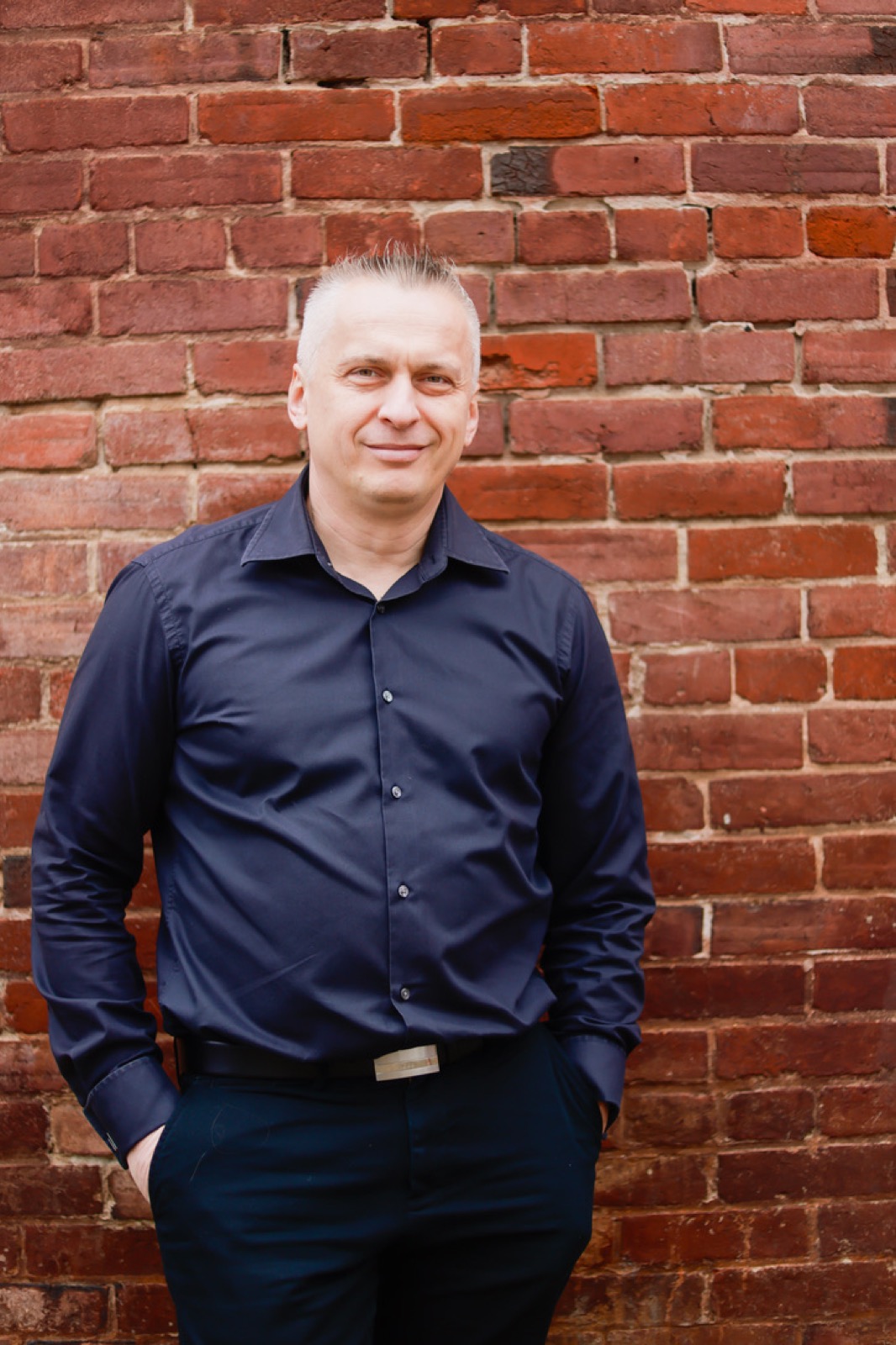 Stan Tscherenkow portrait against a brick wall