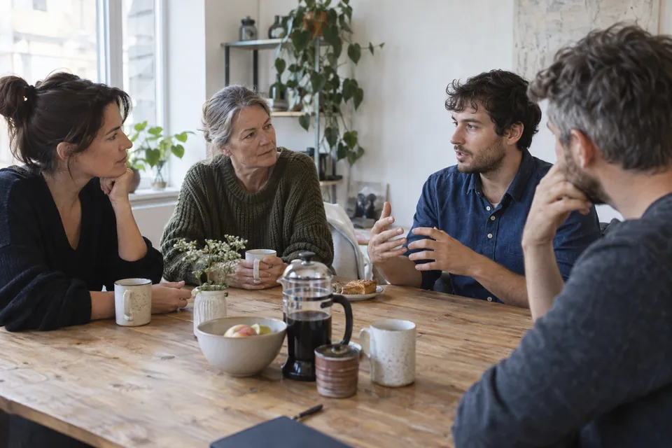 Four business owners exchange perspectives in an informal working conversation.